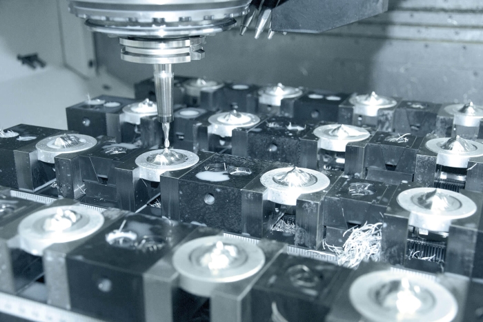 a machining setup with multiple workpieces secured in fixtures on a machine